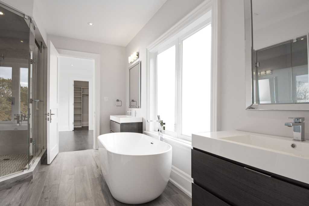 Black pearl custom home bathroom with luxury bath