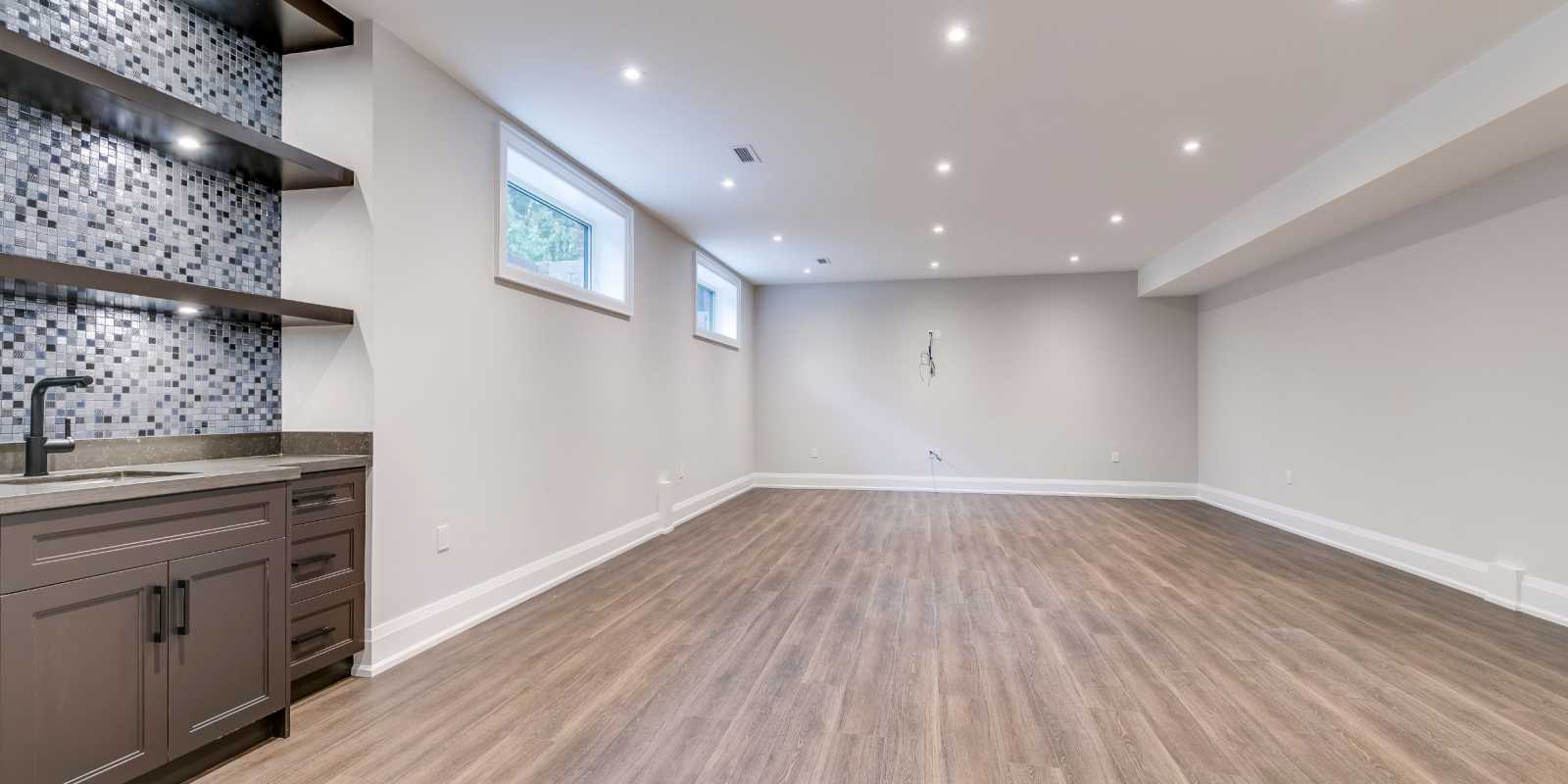 open space basement with wet bar - basement design ideas by black pearl custom homes